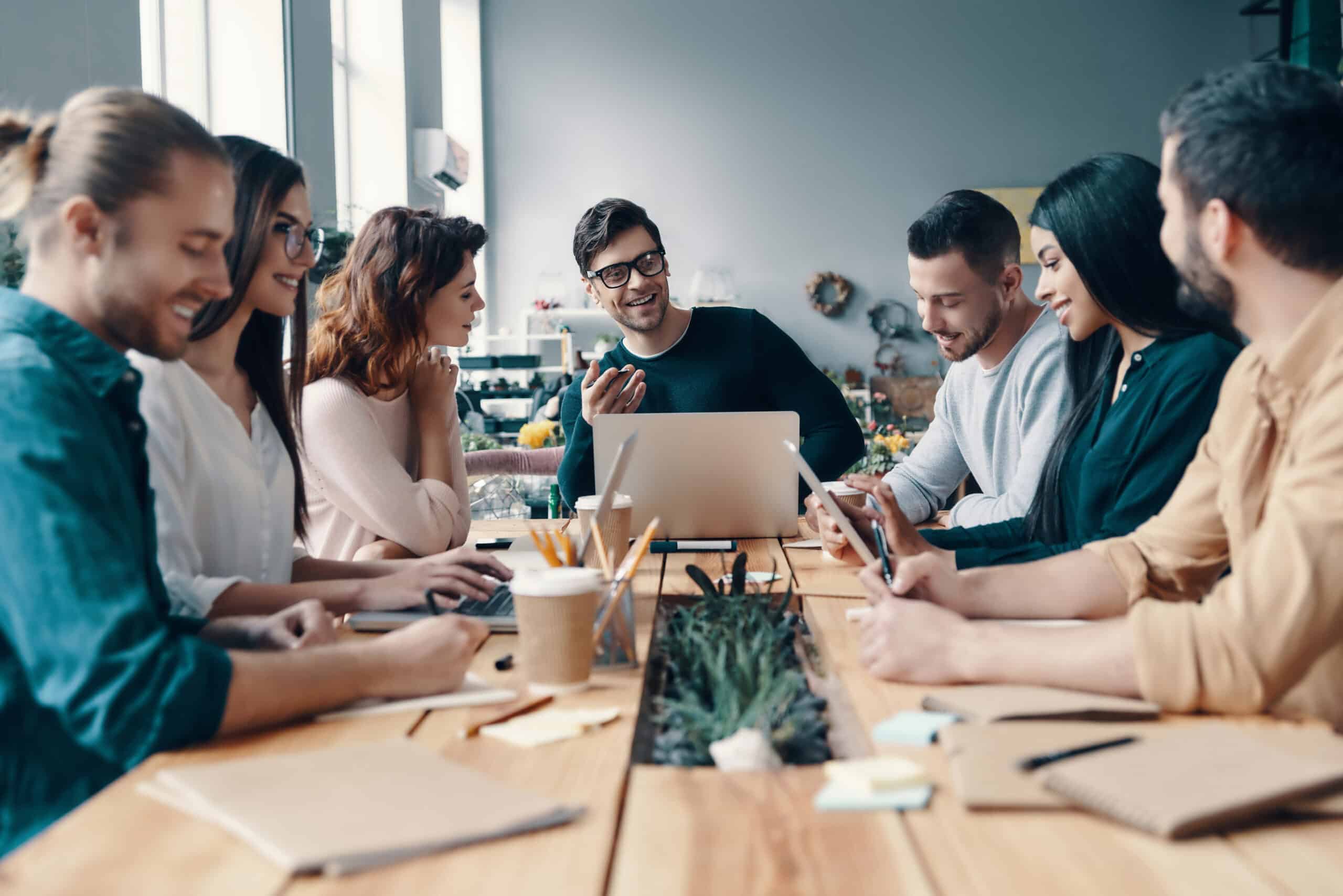 Marketing & Rebranding specialists at work around a table, collaborating on a project