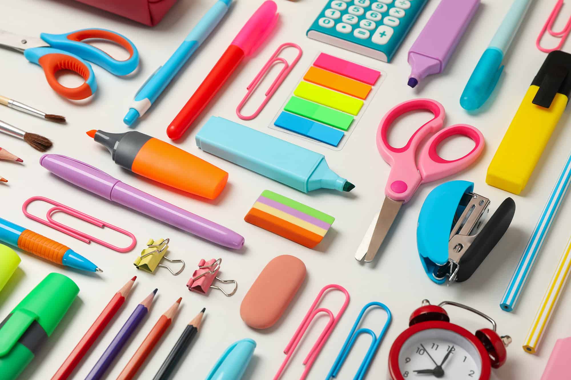 Flat lay with different school supplies on white background