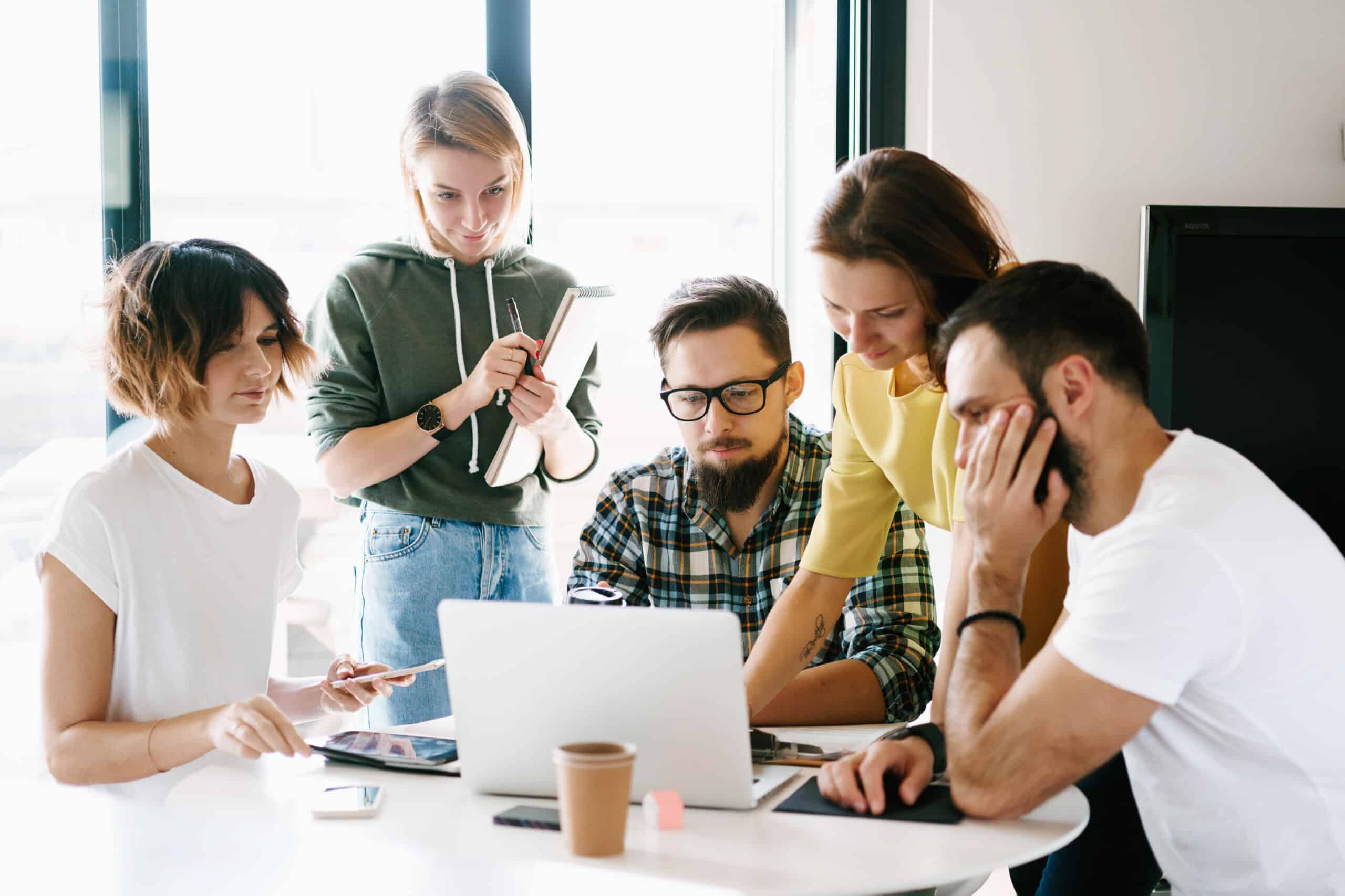 Product Specialists at work in a group meeting looking at a laptop