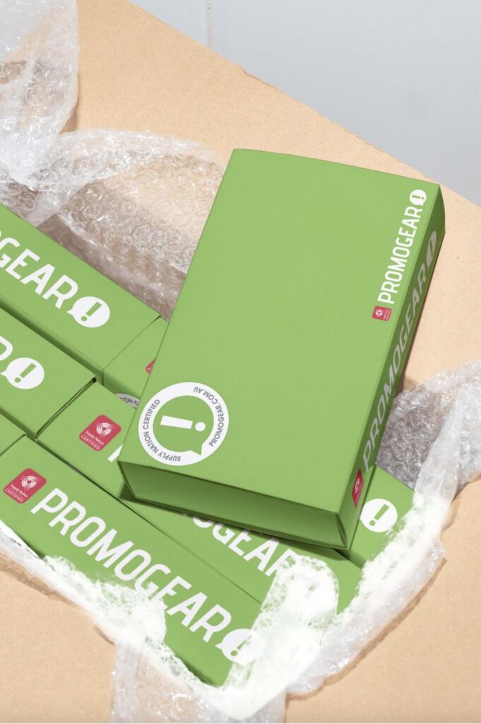 a picture of green packaging boxes with promogear's logo